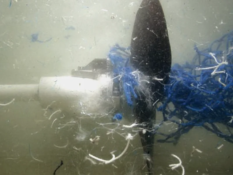 Diver clearing fouling from a vessel propeller