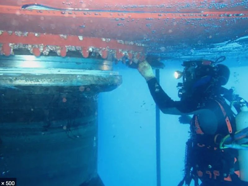 Diver carrying out underwater structural inspection