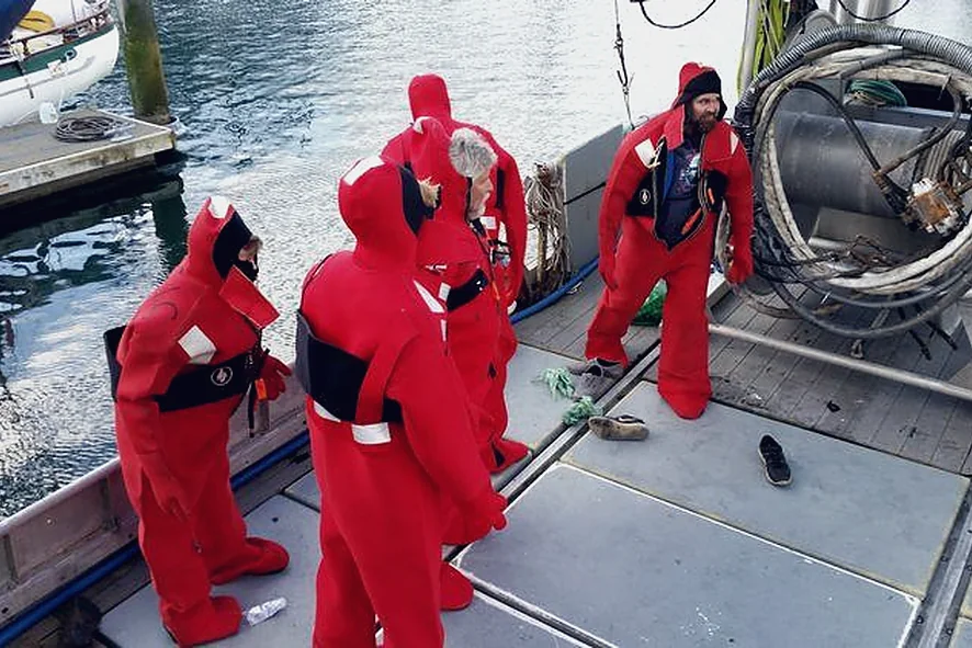 Crew in immersion suits during a safety exercise