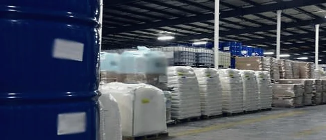 Drums and sacked goods stored in a warehouse